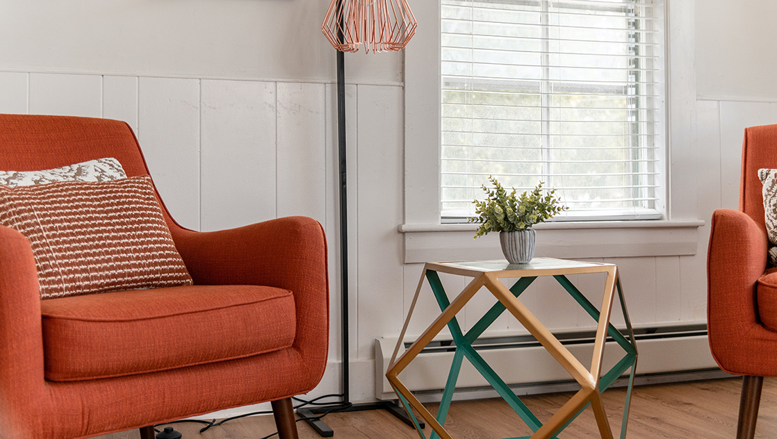 A lounge area with orange seats.